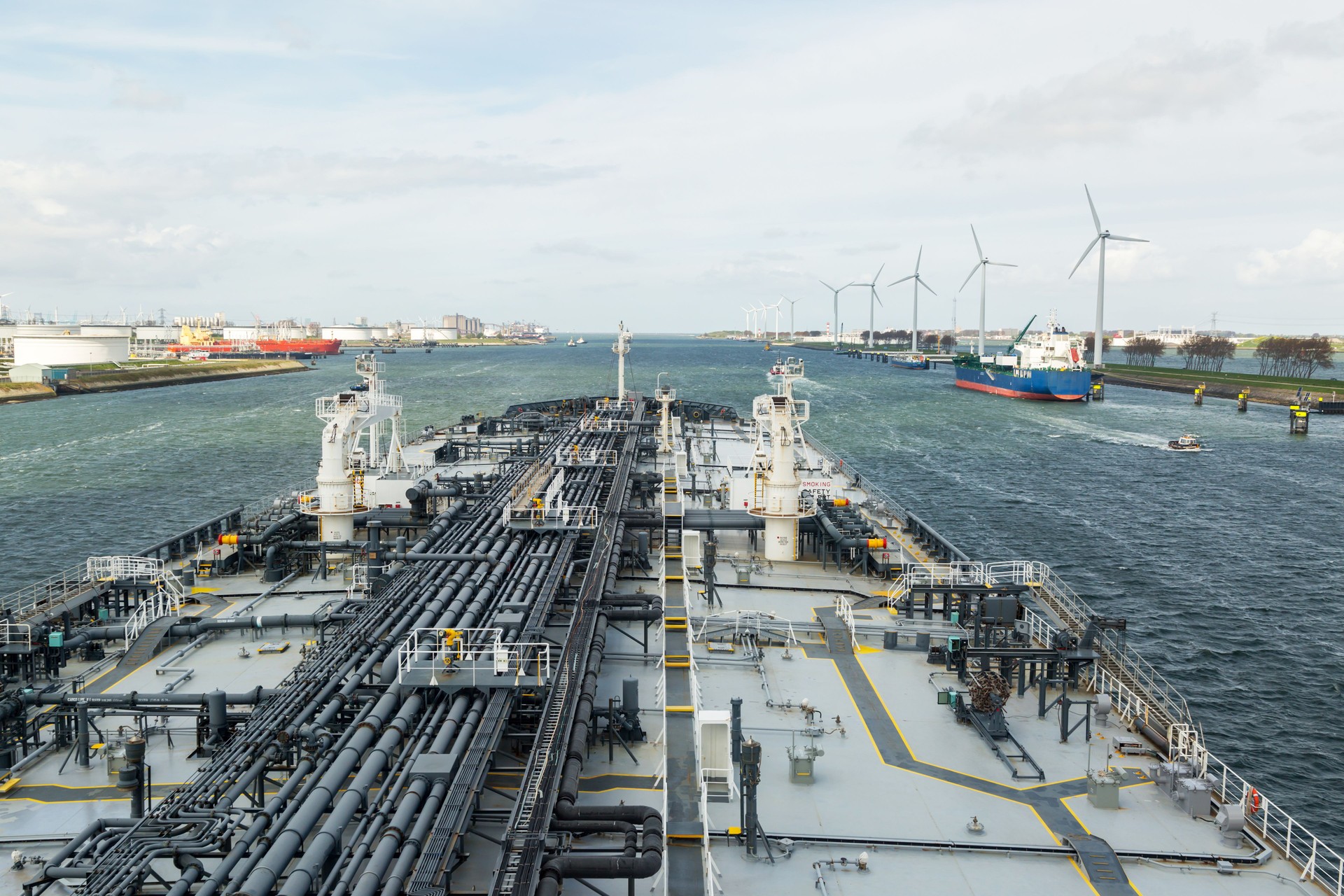 Oil tanker is leaving the port of Rtooterdam.