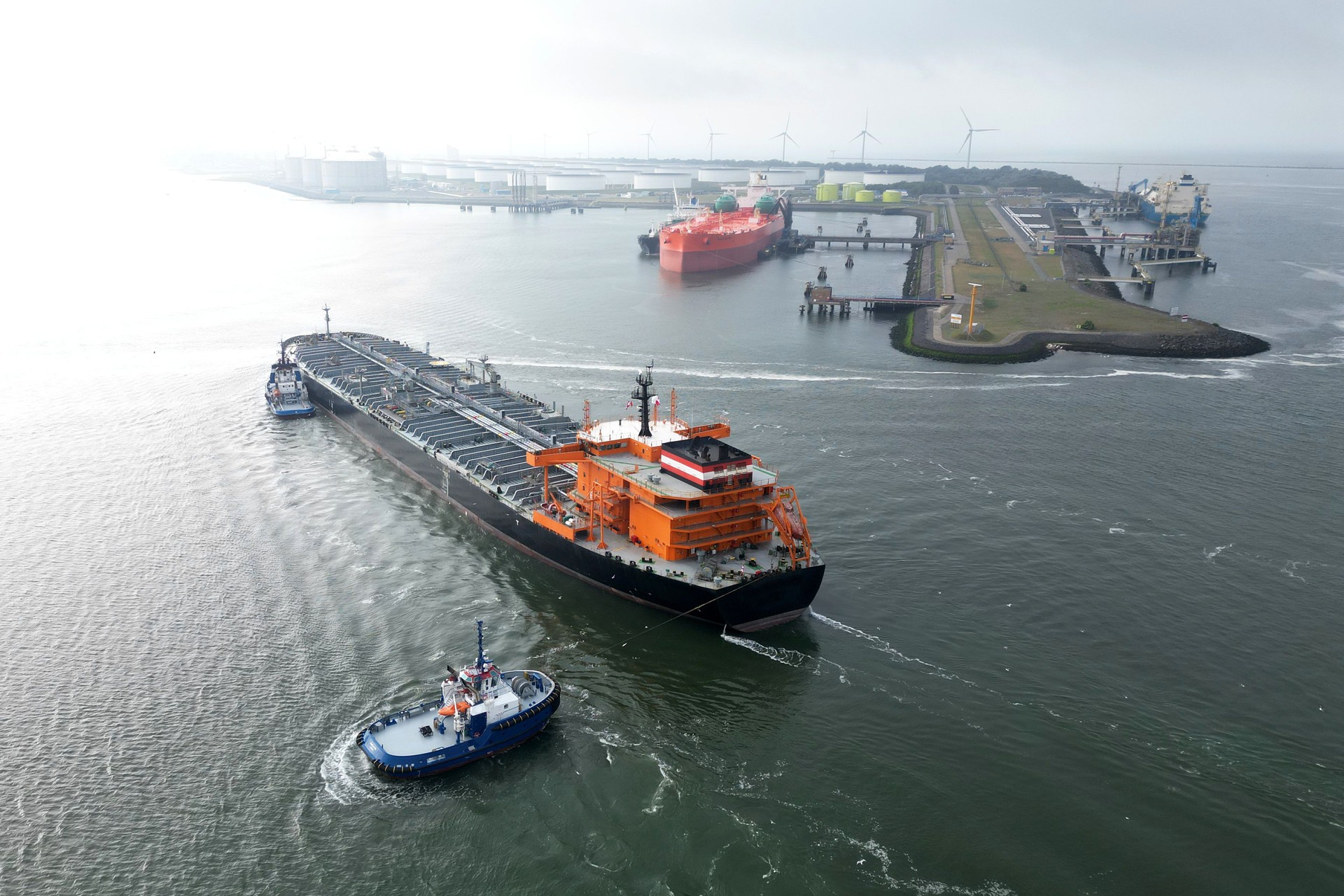 A large oil tanker and tugs in the port of Rotterdam